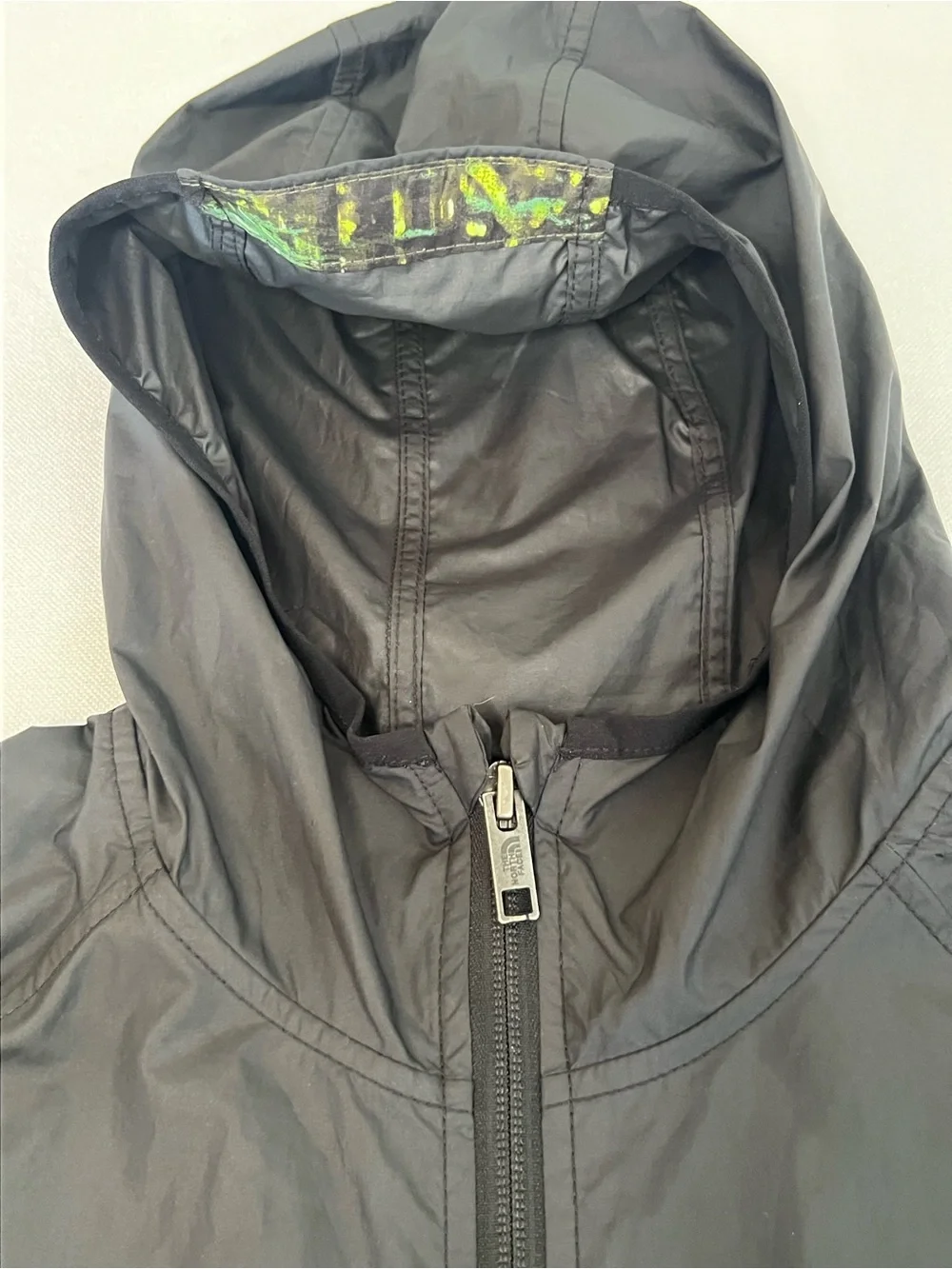 The North Face Kids Black Hooded Rain Jacket with Neon Green Print
